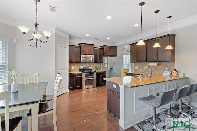 530 Briarcrest Dr NE, Ludowici, GA 31316 - kitchen with a sink, visible vents, a peninsula, appliances with stainless steel finishes, and dark wood-style floors