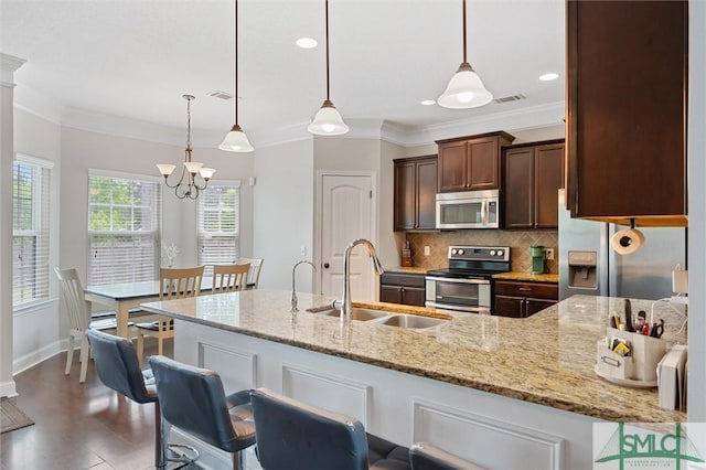 530 Briarcrest Dr NE, Ludowici, GA 31316 - kitchen with dark brown cabinets, a sink, appliances with stainless steel finishes, and crown molding