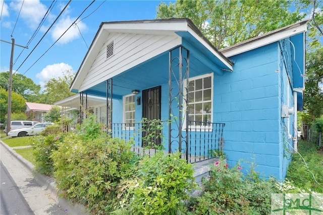 627 W 48th St, Savannah, GA 31405 - view of property exterior with a porch and concrete block siding