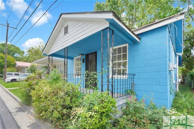 627 W 48th St, Savannah, GA 31405 - view of property exterior featuring covered porch and concrete block siding