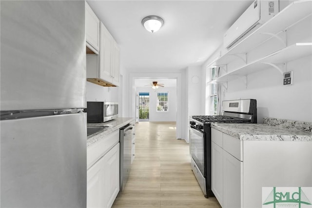 627 W 48th St, Savannah, GA 31405 - kitchen with light wood-style floors, a ceiling fan, open shelves, light countertops, and appliances with stainless steel finishes