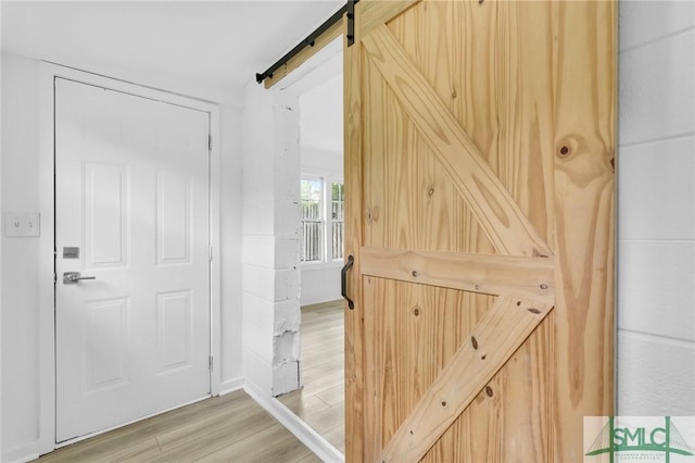 627 W 48th St, Savannah, GA 31405 - interior space with a barn door and light wood-style flooring