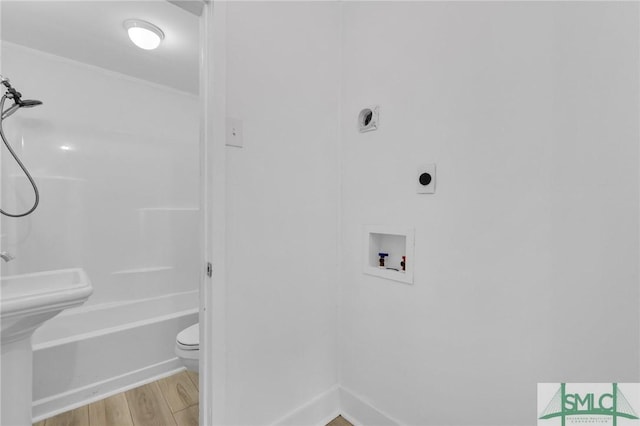 627 W 48th St, Savannah, GA 31405 - bathroom with wood finished floors, toilet, ornamental molding, and a sink