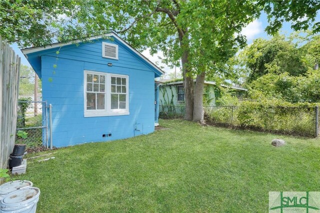 627 W 48th St, Savannah, GA 31405 - exterior space with a lawn, crawl space, and fence
