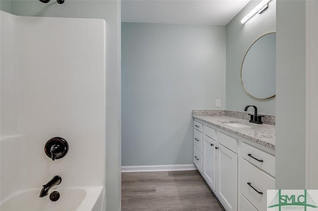 126 Four Oaks Ct, Rincon, GA 31326 - bathroom featuring baseboards, wood finished floors, shower / washtub combination, and vanity