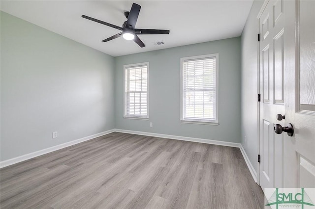126 Four Oaks Ct, Rincon, GA 31326 - unfurnished room featuring baseboards, visible vents, wood finished floors, and ceiling fan
