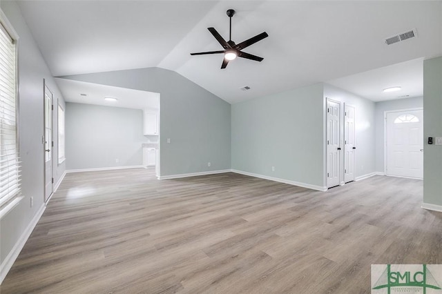 126 Four Oaks Ct, Rincon, GA 31326 - unfurnished living room with ceiling fan, visible vents, light wood-style flooring, vaulted ceiling, and baseboards
