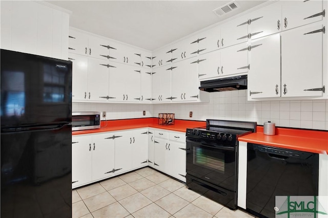 kitchen with black appliances, visible vents, under cabinet range hood, and tasteful backsplash