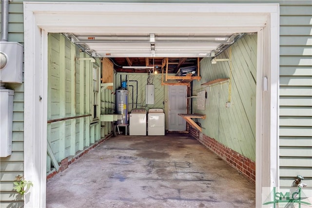 garage featuring electric water heater, separate washer and dryer, and electric panel