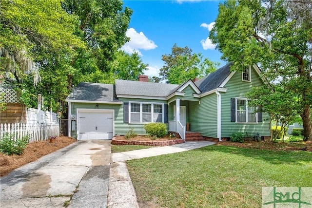 view of front facade featuring a front lawn, driveway, a chimney, an attached garage, and fence