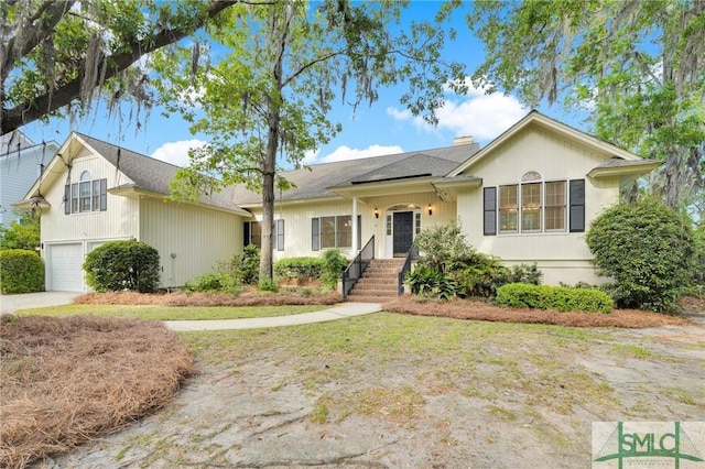 ranch-style house featuring an attached garage and driveway