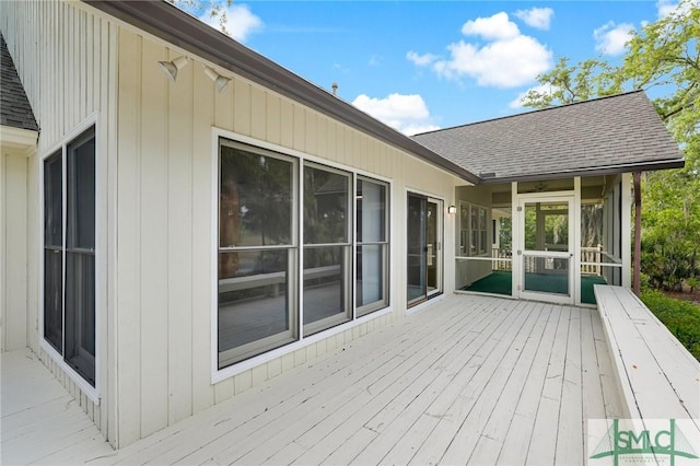 wooden deck featuring a sunroom