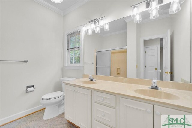 full bathroom featuring a shower stall, toilet, crown molding, and a sink