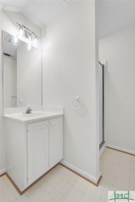 bathroom with baseboards, visible vents, tile patterned floors, and vanity