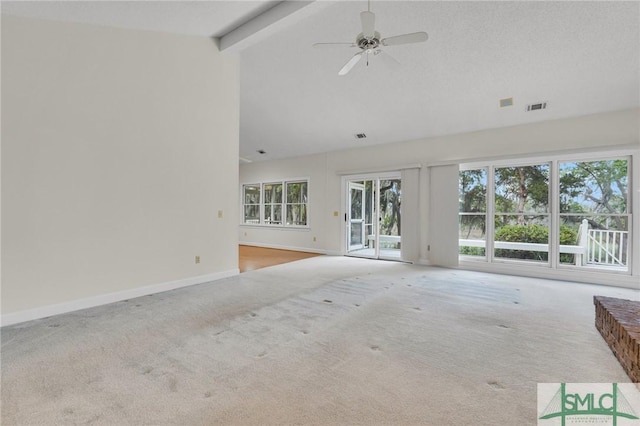 unfurnished living room featuring carpet, visible vents, beamed ceiling, baseboards, and ceiling fan
