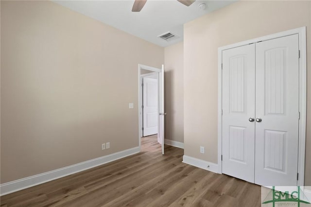 620 W 9th St, Rincon, GA 31326 - unfurnished bedroom with wood finished floors, visible vents, a closet, baseboards, and ceiling fan