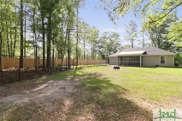 620 W 9th St, Rincon, GA 31326 - view of yard with a fire pit, fence private yard, and a sunroom