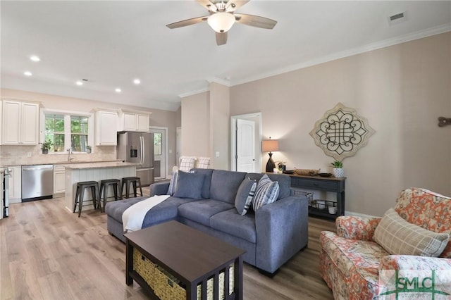 620 W 9th St, Rincon, GA 31326 - living area with crown molding, ceiling fan, light wood-style flooring, visible vents, and recessed lighting