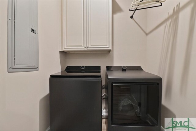 620 W 9th St, Rincon, GA 31326 - clothes washing area featuring washing machine and clothes dryer, cabinet space, and electric panel