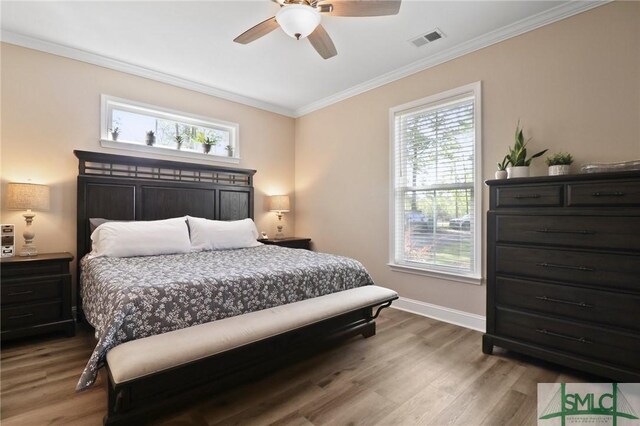 620 W 9th St, Rincon, GA 31326 - bedroom with wood finished floors, visible vents, ornamental molding, and multiple windows