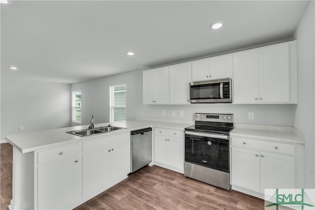 19 Arrowhead Way, Port Wentworth, GA 31407 - kitchen with a sink, a peninsula, stainless steel appliances, and white cabinetry