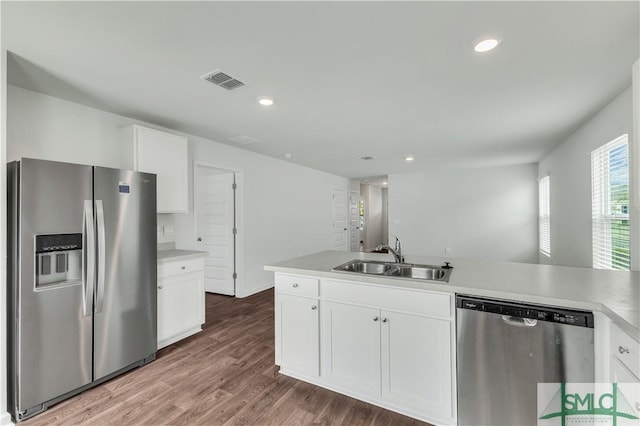 19 Arrowhead Way, Port Wentworth, GA 31407 - kitchen featuring a sink, stainless steel appliances, visible vents, white cabinets, and wood finished floors