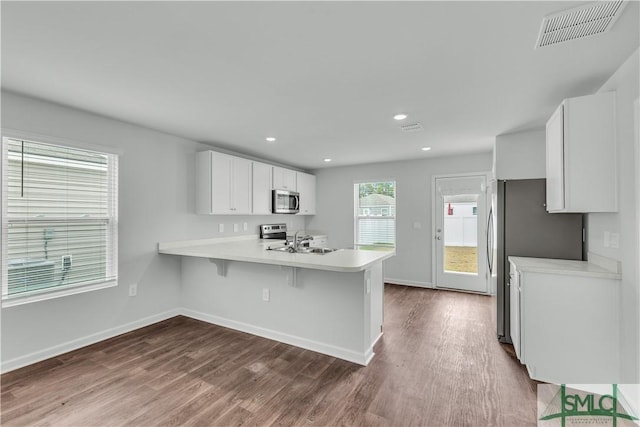 19 Arrowhead Way, Port Wentworth, GA 31407 - kitchen featuring visible vents, stainless steel appliances, light countertops, and dark wood finished floors