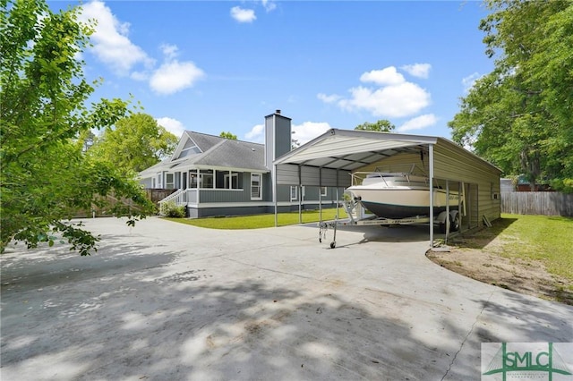 116 Rose Dhu Way, Savannah, GA 31419 - back of house with a detached carport, driveway, and a chimney