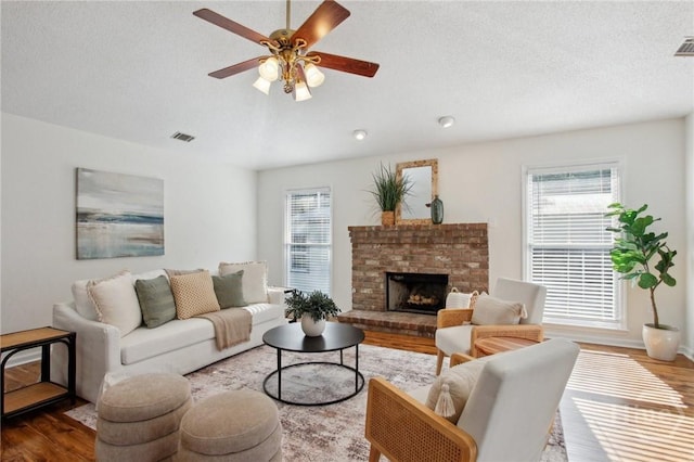 116 Rose Dhu Way, Savannah, GA 31419 - living area featuring wood finished floors, healthy amount of natural light, ceiling fan, and a textured ceiling