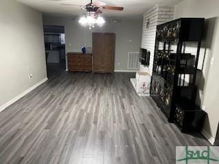 unfurnished living room with baseboards, wood finished floors, and ceiling fan