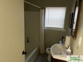 full bath featuring shower / bath combination with curtain, toilet, and vanity