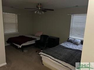 carpeted bedroom featuring a ceiling fan and baseboards