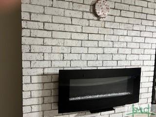 room details featuring a brick fireplace