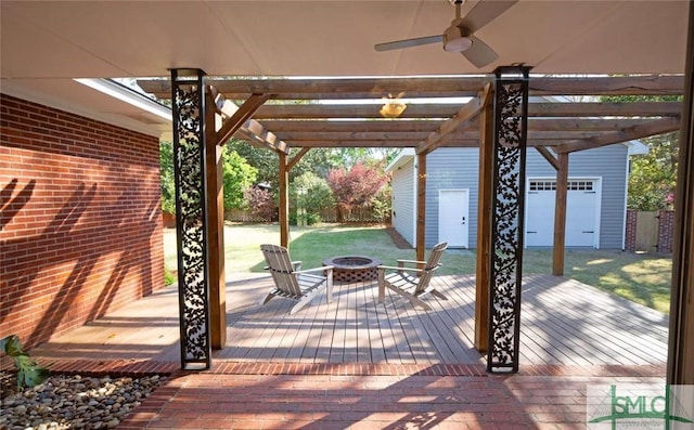 exterior space featuring a ceiling fan and an outdoor fire pit