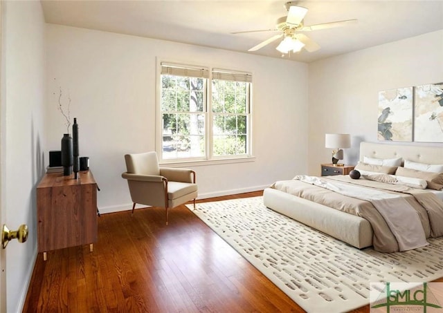 bedroom with baseboards, a ceiling fan, and dark wood-style flooring