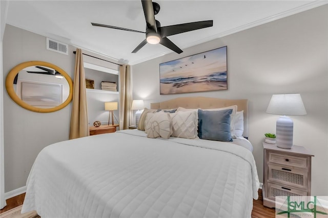 1217 Bay St Unit 230A, Tybee Island, GA 31328 - bedroom with ceiling fan, visible vents, baseboards, ornamental molding, and wood finished floors
