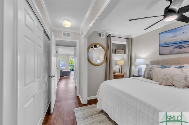 1217 Bay St Unit 230A, Tybee Island, GA 31328 - bedroom featuring crown molding, dark wood-style floors, visible vents, and baseboards