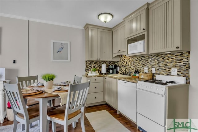 1217 Bay St Unit 230A, Tybee Island, GA 31328 - kitchen featuring dark wood finished floors, tasteful backsplash, white appliances, cream cabinets, and a sink