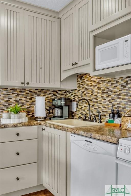1217 Bay St Unit 230A, Tybee Island, GA 31328 - kitchen featuring tasteful backsplash, white appliances, light countertops, and a sink