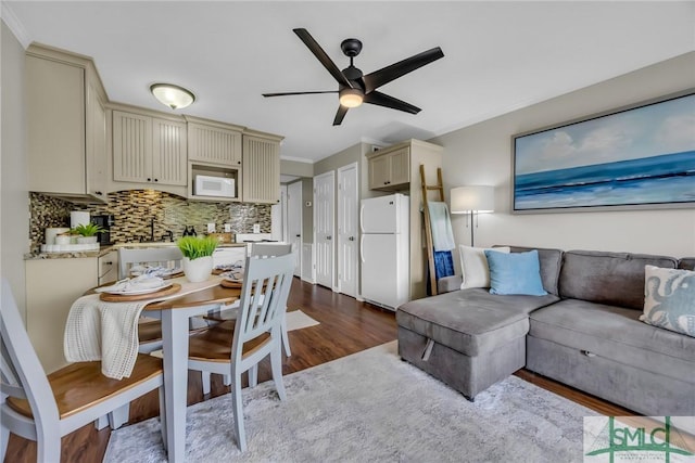1217 Bay St Unit 230A, Tybee Island, GA 31328 - living area with crown molding, ceiling fan, and dark wood finished floors