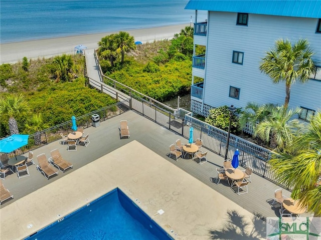 1217 Bay St Unit 230A, Tybee Island, GA 31328 - view of swimming pool featuring fence, a view of the beach, and a water view