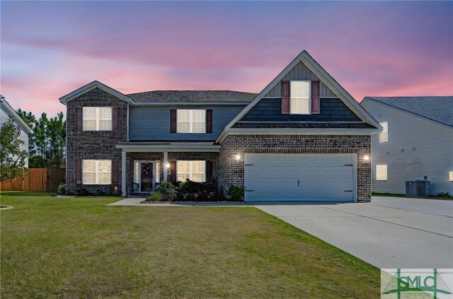 traditional-style home featuring driveway, fence, brick siding, and a front lawn