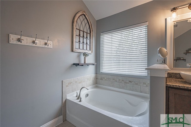 full bath featuring a garden tub and vanity