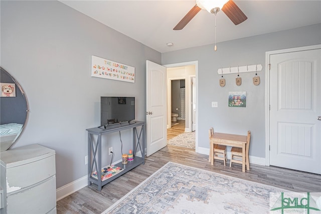 recreation room featuring ceiling fan, wood finished floors, and baseboards