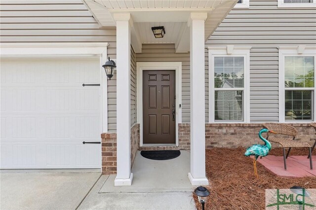 378 Southwilde Way, Pooler, GA 31322 - property entrance featuring an attached garage and brick siding