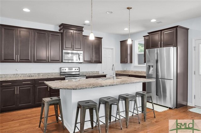 378 Southwilde Way, Pooler, GA 31322 - kitchen with a sink, dark brown cabinetry, stainless steel appliances, and light wood-style flooring