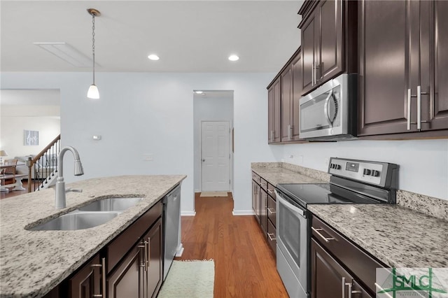 378 Southwilde Way, Pooler, GA 31322 - kitchen with dark wood-style flooring, dark brown cabinetry, appliances with stainless steel finishes, a sink, and decorative light fixtures