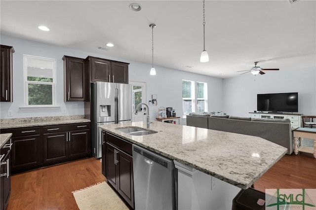 378 Southwilde Way, Pooler, GA 31322 - kitchen featuring ceiling fan, appliances with stainless steel finishes, light stone counters, a sink, and wood finished floors