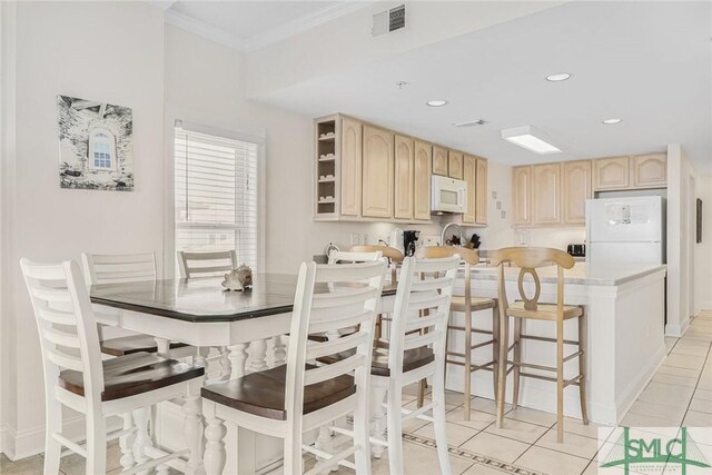 1609 Strand Ave Unit 206, Tybee Island, GA 31328 - dining room featuring light tile patterned floors, ornamental molding, and recessed lighting