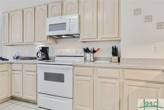 1609 Strand Ave Unit 206, Tybee Island, GA 31328 - kitchen with white appliances, cream cabinetry, and light countertops